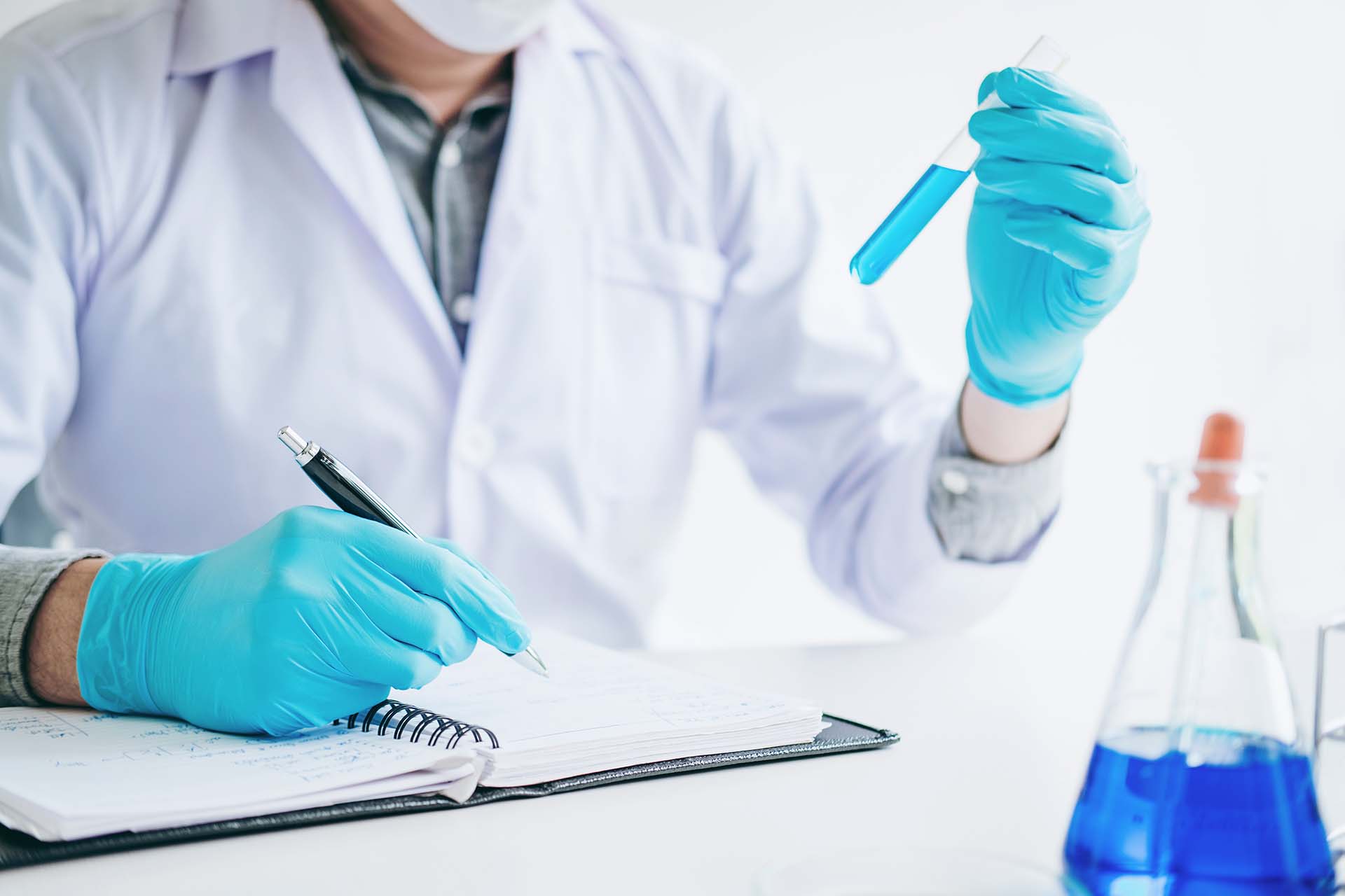 Scientist with equipment holding tools during scientific experiment science concept